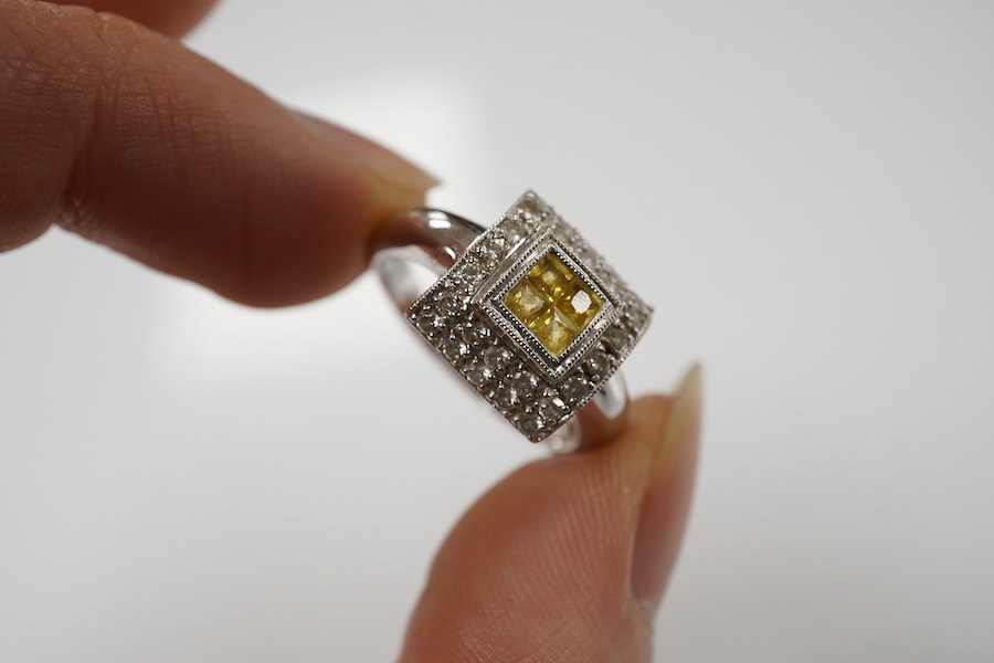 A modern 18ct white gold, yellow sapphire and diamond chip set square cluster ring, size N/O, gross weight 5.1 grams. Condition - fair to good